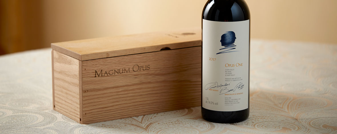 A magnum of Opus One 2017 next to a wooden gift box